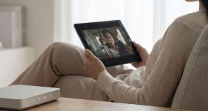 A person watching movie at home using her tablet